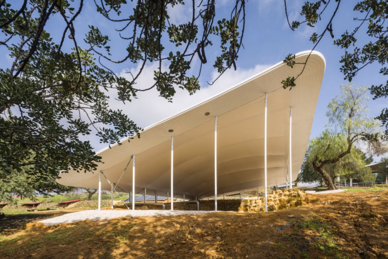The textile membrane canopy among the vegetation of the Carmona Archaeological Complex seen from an elevated position. Nd_Arquitectos. Spain. Photo by Jesús Granada.