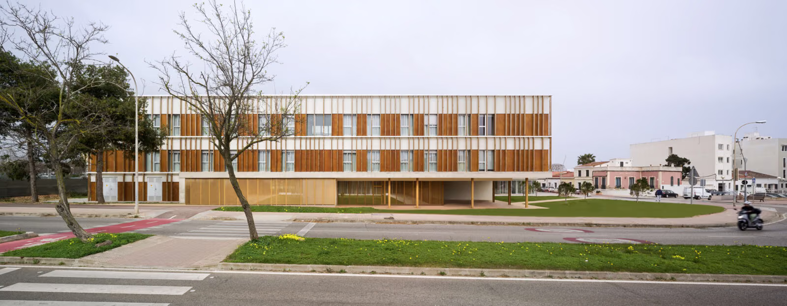 Panoramic view of the complex from a distance, the two interlocking volumes over the former camí d'en Guixò. Residence for the Elderly in Mahón, Menorca. Antonio González Liñán, SV60 Arquitectos. Photography by Jesús Granada.