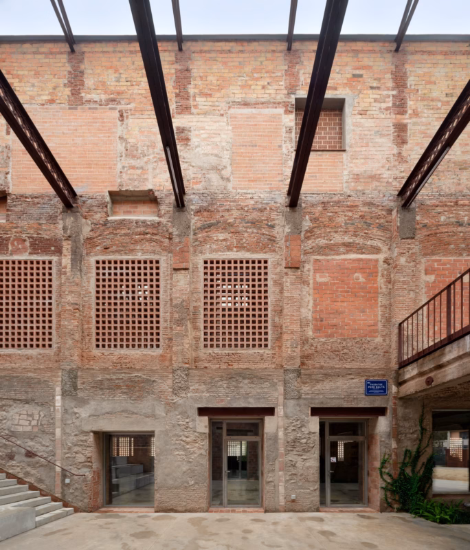 Interior façade facing the recovered pedestrian passage between the naves. PRODIS Centre in Terrassa, Spain. Harquitectes. Photography by Jesús Granada.